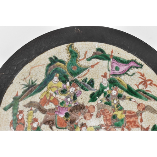 8 - A pair of Chinese famille verte-style crackleware chargers, late Qing dynasty, each painted with war... 