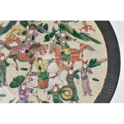 8 - A pair of Chinese famille verte-style crackleware chargers, late Qing dynasty, each painted with war... 