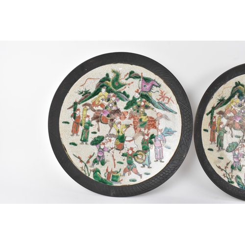 8 - A pair of Chinese famille verte-style crackleware chargers, late Qing dynasty, each painted with war... 