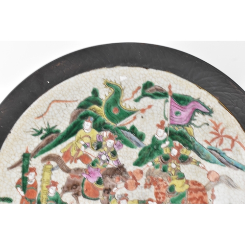 8 - A pair of Chinese famille verte-style crackleware chargers, late Qing dynasty, each painted with war... 