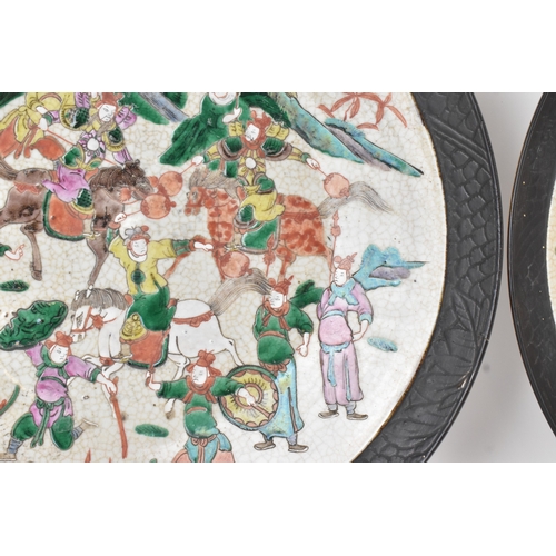 8 - A pair of Chinese famille verte-style crackleware chargers, late Qing dynasty, each painted with war... 