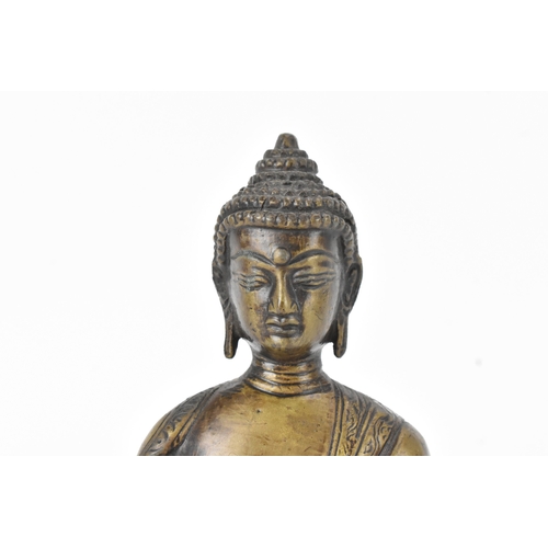 9 - A 19th century bronze figure of Buddha, seated in dhyanasana on a double lotus base, the right hand ... 
