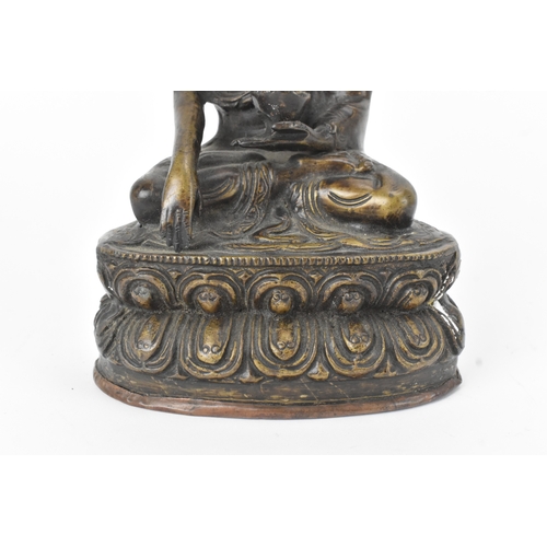 9 - A 19th century bronze figure of Buddha, seated in dhyanasana on a double lotus base, the right hand ... 