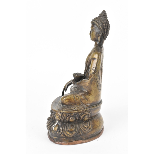 9 - A 19th century bronze figure of Buddha, seated in dhyanasana on a double lotus base, the right hand ... 