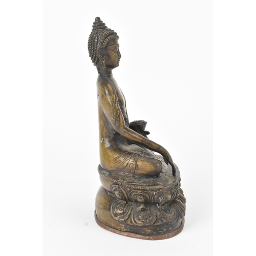 9 - A 19th century bronze figure of Buddha, seated in dhyanasana on a double lotus base, the right hand ... 