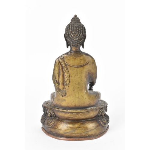 9 - A 19th century bronze figure of Buddha, seated in dhyanasana on a double lotus base, the right hand ... 