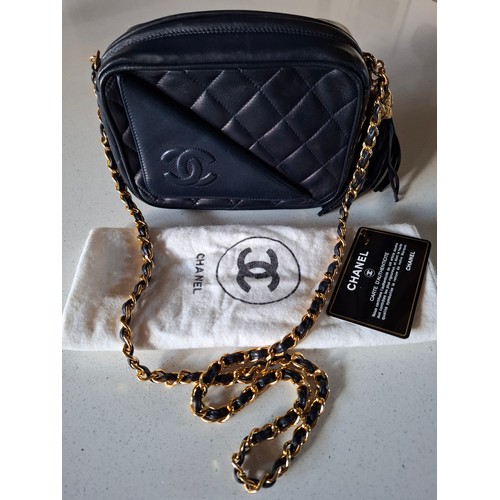 Chanel- A late 1980's/early 1990's navy lambskin leather Matrasse Fringe quilted crossbody bag, 18cm wide x 12cm high x 6cm deep, having a tasselled fringe to the zipper, Interlocking CC logo, gold tone hardware and partial chain and leather shoulder strap having a Chanel Certificate of Authenticity card no:1561648 (matches Chanel sticker number on inside zipped pocket) and branded dust bag. Location:Cab