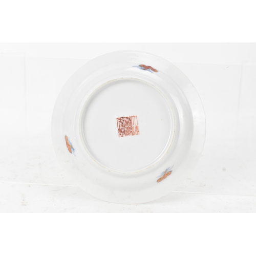 45A - A pair of Chinese famille-verte porcelain cups and saucers, each cup of flared form, decorated with ... 