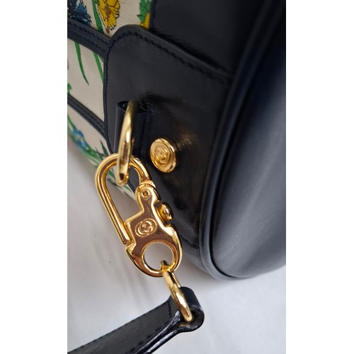 2 - Gucci- A drawstring flora bucket bag having navy leather trim and handles, gold tone hardware, seria... 