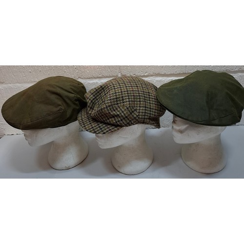 24 - Barbour & Belstaff- A Barbour tweed flat cap size 7⅜, a Barbour green wax cotton flat cap size 7⅝, a... 