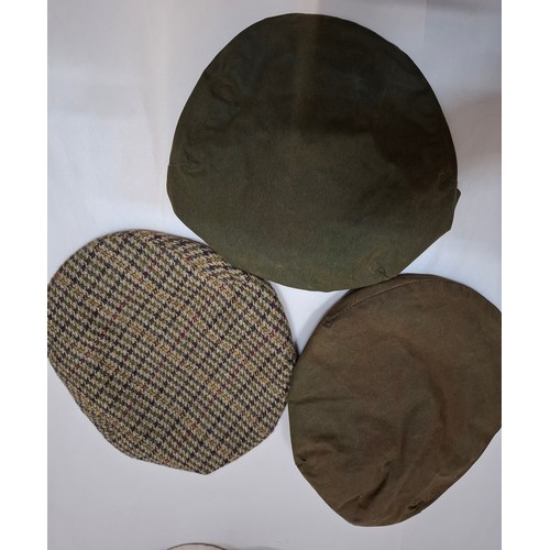 24 - Barbour & Belstaff- A Barbour tweed flat cap size 7⅜, a Barbour green wax cotton flat cap size 7⅝, a... 