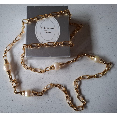 3 - Christian Dior- A gold tone curb link necklace with 4 pearlised beads, stamped Chr.Dior© to clasp, a... 