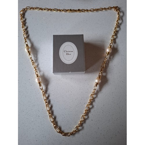 3 - Christian Dior- A gold tone curb link necklace with 4 pearlised beads, stamped Chr.Dior© to clasp, a... 