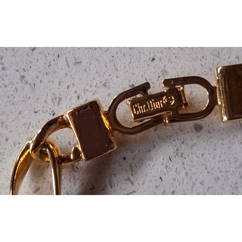 3 - Christian Dior- A gold tone curb link necklace with 4 pearlised beads, stamped Chr.Dior© to clasp, a... 