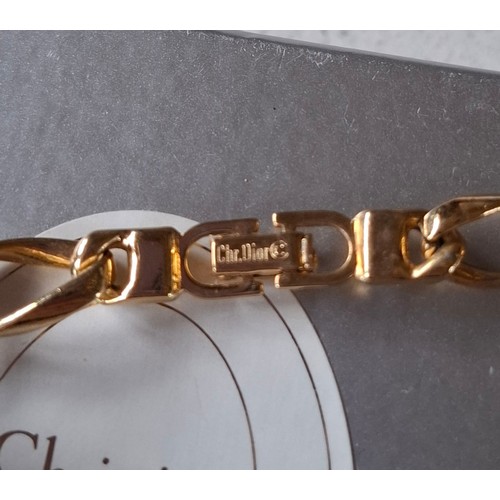 6 - Christian Dior- A gold tone curb link necklace with 4 blue mottled beads, stamped Chr.Dior© to clasp... 