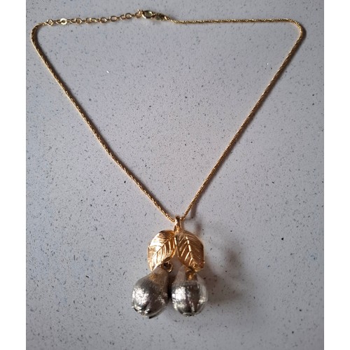 4 - Christian Dior- A gold and silver tone necklace having a double pear and double leaf pendant with Ch... 