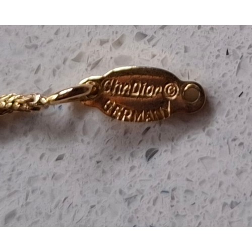 4 - Christian Dior- A gold and silver tone necklace having a double pear and double leaf pendant with Ch... 