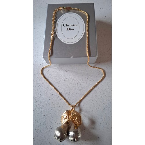 4 - Christian Dior- A gold and silver tone necklace having a double pear and double leaf pendant with Ch... 