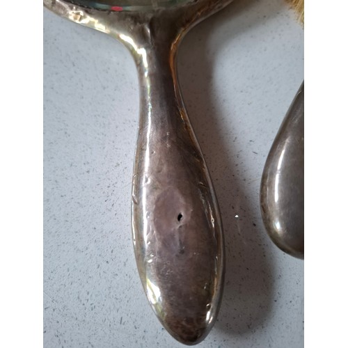 53 - Three matched silver backed dressing table items comprising hand mirror, and 2 brushes, makers mark ... 