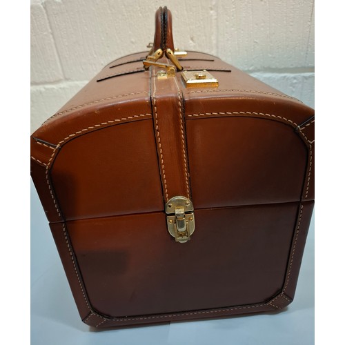 27 - Dunhill- A vintage tan leather Gladstone bag having gold tone hardware, removable tray and cream wat... 