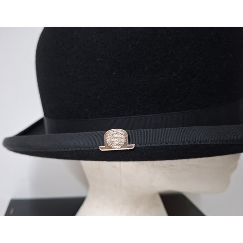 45 - A Lock & Co black felt bowler hat, size L/59/7¼ having a silver tone Lock & Co hat pin to one side w... 