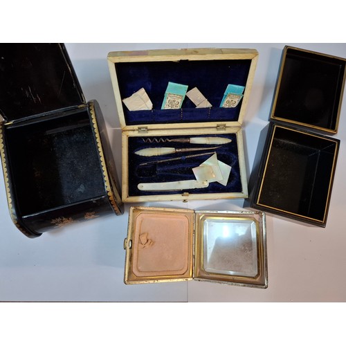 50 - A quantity of compacts to include Kigu, 2 silver topped glass scent bottles, a mother of pearl manic... 