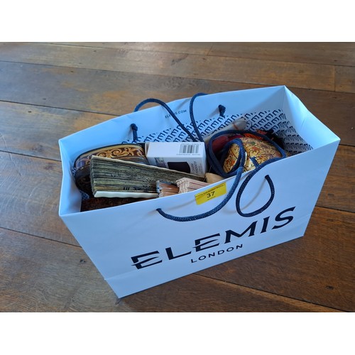 37 - A decorative lot comprising a 1920'S-1950'S Queen Alexandra's Royal Army Nursing Corps armlet badge ... 