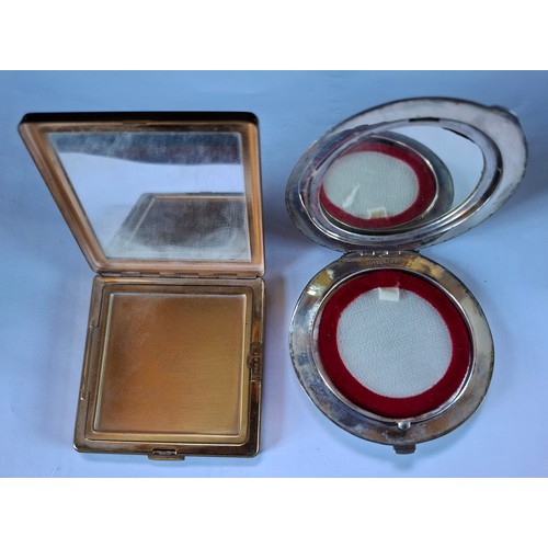 36 - A Sterling silver Niello compact and a Vogue gold tone and black enamel style compact with white gla... 