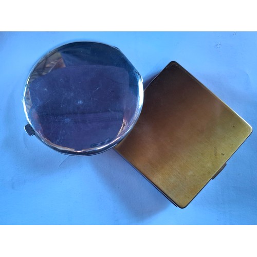 36 - A Sterling silver Niello compact and a Vogue gold tone and black enamel style compact with white gla... 