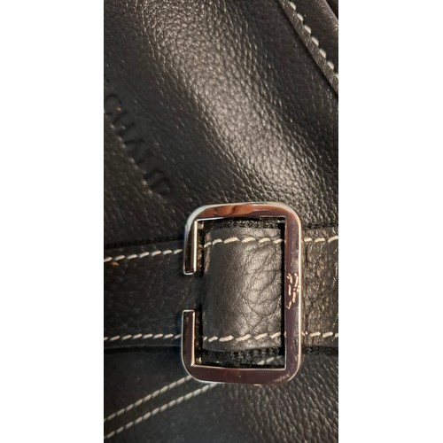 11 - Longchamp- A black leather crossbody bag, 26cm wide x 26cm high, having silver tone hardware, red br... 