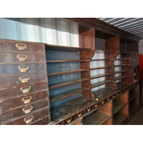 13 - An early 20th Century very large mahogany stained oak shop display cabinet on a plinth base having 1... 