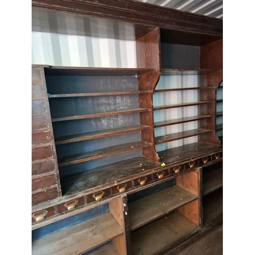 13 - An early 20th Century very large mahogany stained oak shop display cabinet on a plinth base having 1... 
