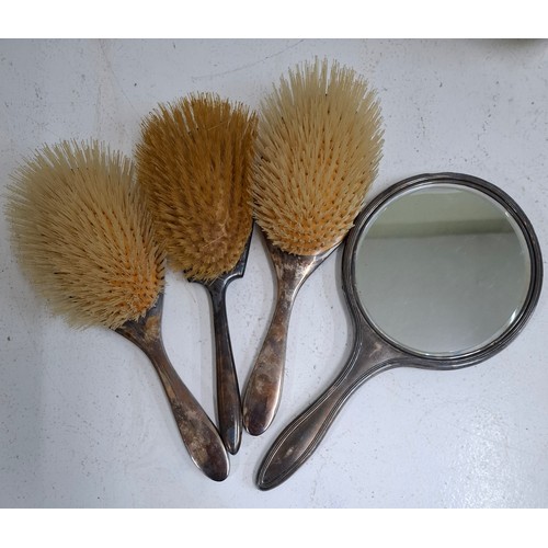 32 - A pair of early 20th Century silver backed hair brushes together with a non-matching silver hand mir... 