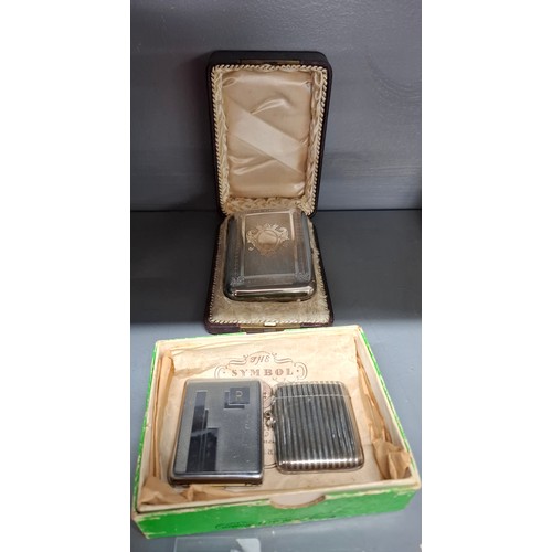 28 - A silver plated cigar case in a fitted leather case along with 2 white metal vesta cases. Location: ... 