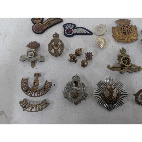 22 - ***THIS LOT HAS BEEN WITHDRAWN*** A collection of military cap badges to include a selection of exam... 