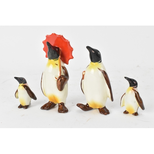 27 - A group of Beswick pottery penguin figures, comprising a family group of four including one adult ho... 