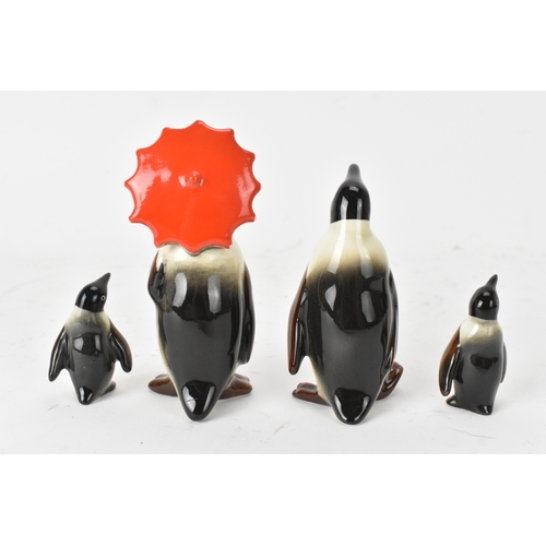 27 - A group of Beswick pottery penguin figures, comprising a family group of four including one adult ho... 