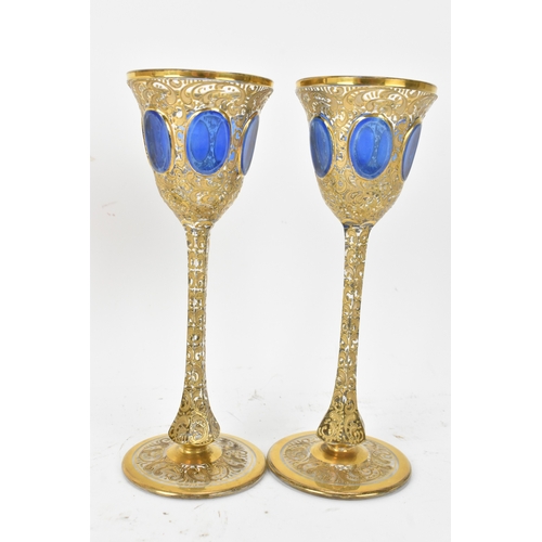 33 - A set of six Bohemian gilt and enamelled wine glasses, possibly by Moser, each with tall slender ste... 
