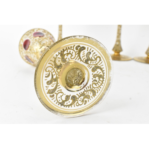 33 - A set of six Bohemian gilt and enamelled wine glasses, possibly by Moser, each with tall slender ste... 