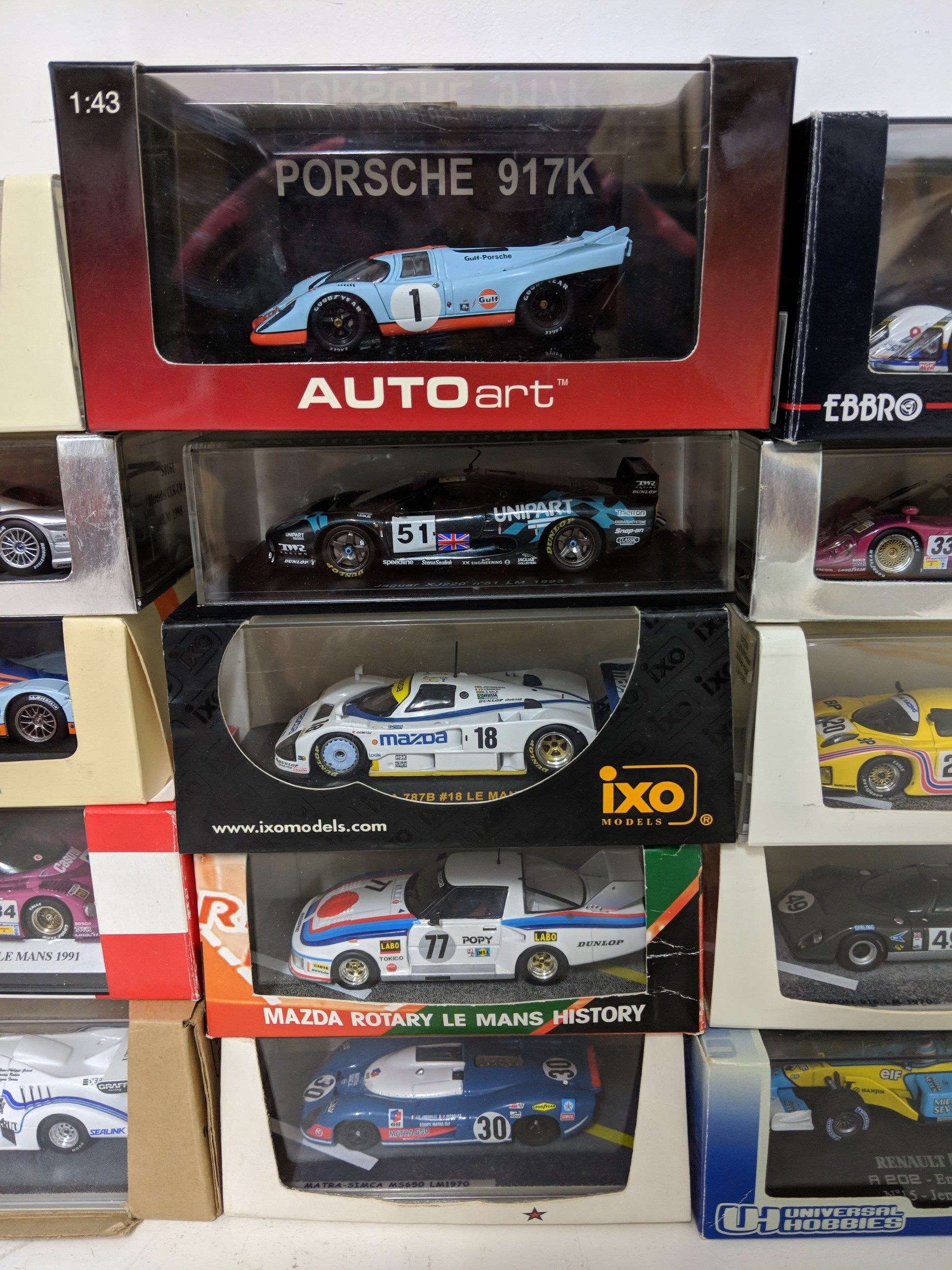Twenty-five cased model racing cars to include Le Mans racing cars ...