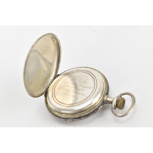 23 - A late 19th century continental silver and niello open face pocket watch, the white enamel dial with... 