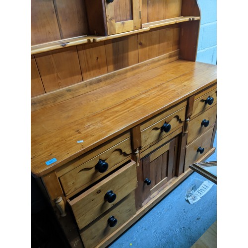 186 - A Victorian pine dresser, the top with two plate shelves, the base with central drawer above cupboar... 
