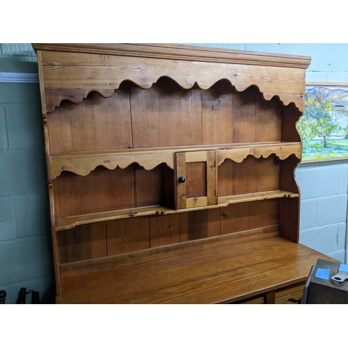 186 - A Victorian pine dresser, the top with two plate shelves, the base with central drawer above cupboar... 
