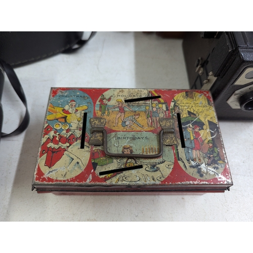 38 - A mixed group of collectables to include Robertsons Advertising Gollies, a vintage money tin and oth... 