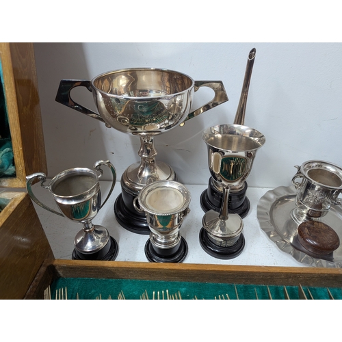 57 - Mixed metalware to include a selection of silverplated trophy cups together with a Thai bronze and w... 
