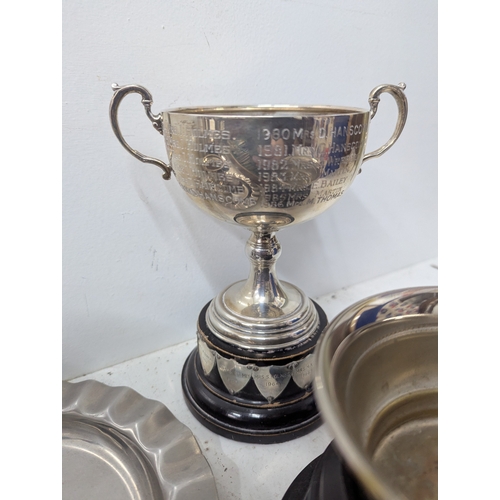 57 - Mixed metalware to include a selection of silverplated trophy cups together with a Thai bronze and w... 