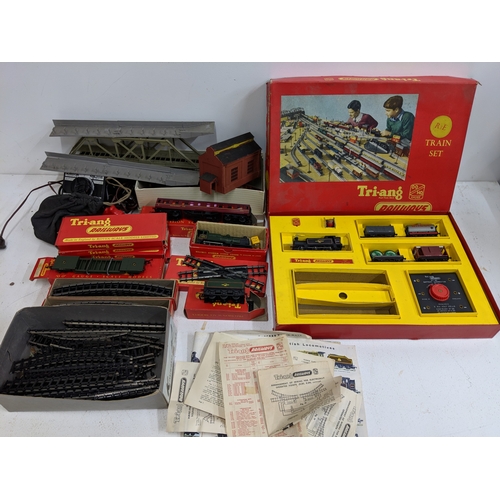 335 - Triang 00/H0 gauge railway track, carriages and other accessories to include buildings and power- pa... 