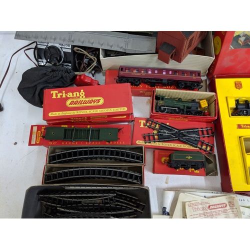 335 - Triang 00/H0 gauge railway track, carriages and other accessories to include buildings and power- pa... 