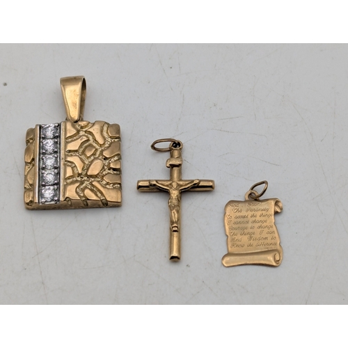 102 - Three yellow gold pendants to include a crucifix and one other, both tested as 9ct gold and the othe... 