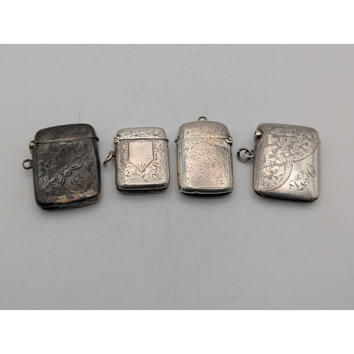 109 - Four silver vesta cases, all having floral engraved decoration, three with hinged lids and suspensio... 